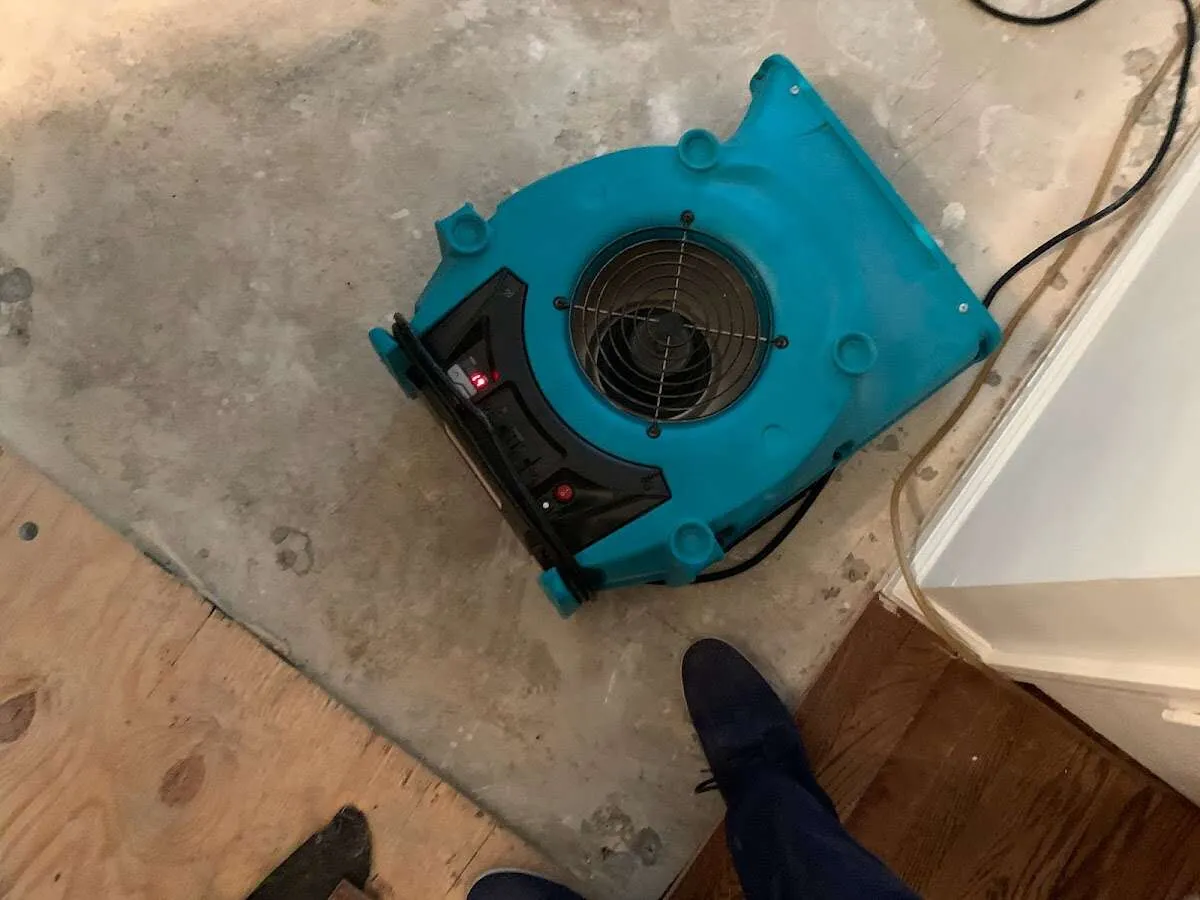 Air mover drying subfloor during Commercial Water Damage Restoration in Candlewick Lake